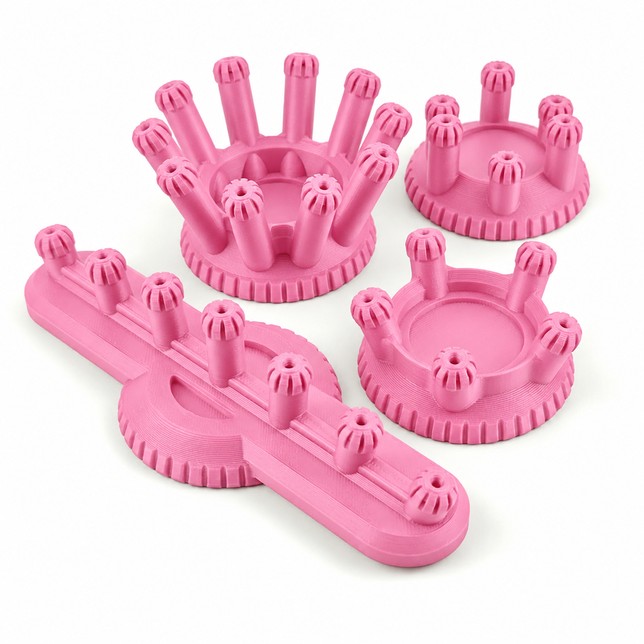 Four light pink PLA sub assembly jigs for miniature painting handles